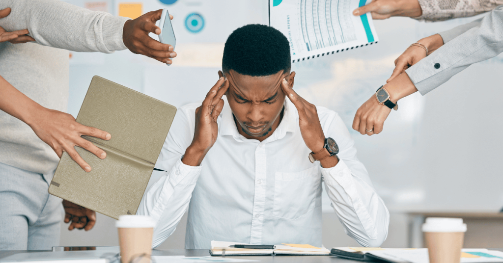 A business owner at a cluttered desk overwhelmed with accounts receivable pitfalls